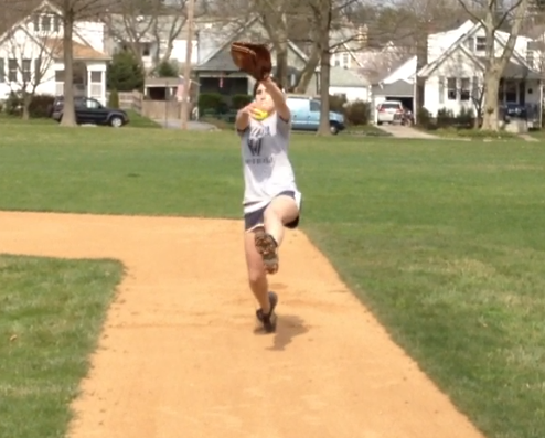 Demonstration of a proper reach in windmill pitching